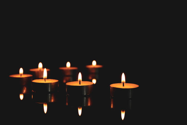 istock Burning candles in holders on table against dark background, space for text 1316768940