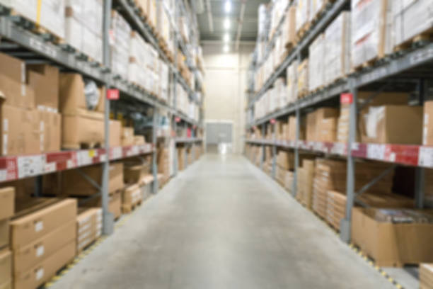 istock Blur background of warehouse. Blurred storehouse shelfs with boxes 1316768944
