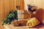 Interior details Finnish sauna steam room bathhouse with traditional sauna accessories basin birch broom scoop felt hat towel