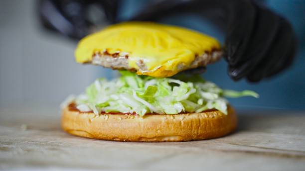 istock Chef in black gloves prepares a hamburger. 1316772587