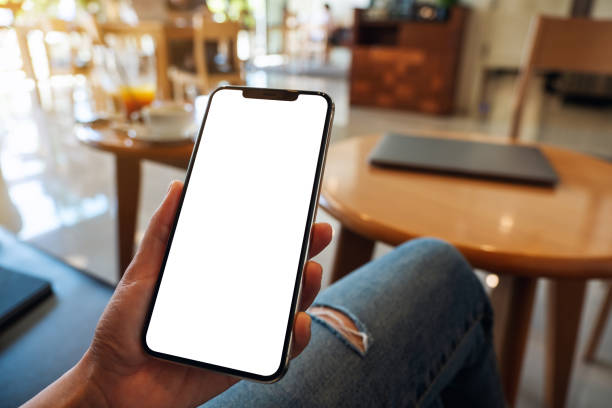 istock a woman holding mobile phone with blank white desktop screen 1316772632