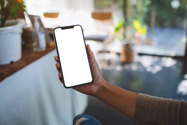 istock a woman holding mobile phone with blank white desktop screen 1316772649