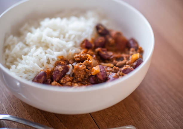 istock Meat chili con carne and rice on a wooden table 1316772707