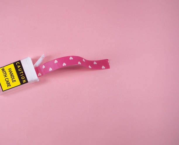 istock Plastic package with caution handle with care writing. Washy tapes with hearts coming out 1316772772