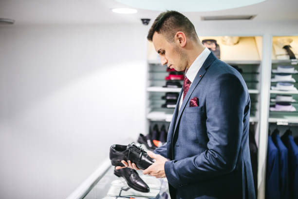 istock Elegant man, in suit, buying shoes 1316773806