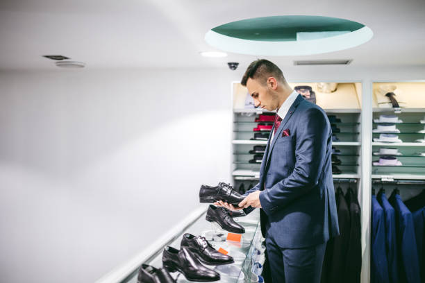 istock Elegant man, in suit, buying shoes 1316773826