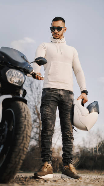 istock The motorcyclist is standing next to his motorcycle. 1316773973