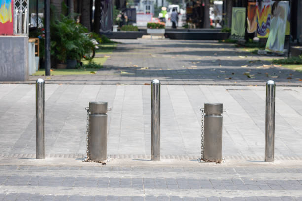 istock stainless steel bollards at concrete pavement. 1316775371