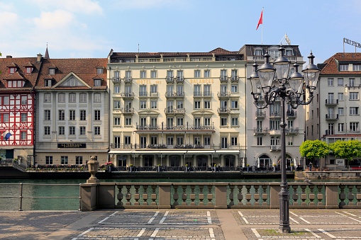 Lucerne, Switzerland - May 02, 2016: Colorful buildings of the city along river Reuss shows its unique character and variety of sightseeing attractions. The town is a destination for many travelers.