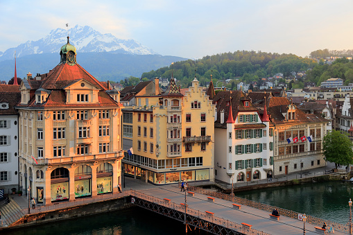 Lucerne, Switzerland - May 02, 2016: Townhouses down by the river Reuss shows the unique character of the city and variety of sightseeing attractions. The town is a destination for many travelers.