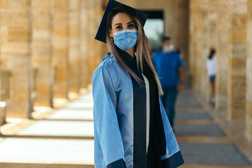 Female graduate student  with protective face mask