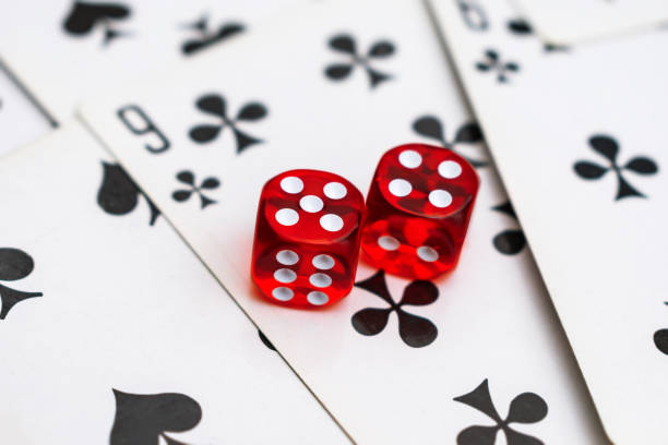 istock Dice on cards in a casino with a drawn nine 1316777856
