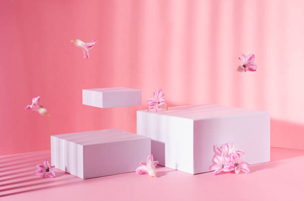 istock Bright spring mock up for cosmetic and product display with three white square podiums, tender hyacinth flowers flying in sun beam on pastel pink background. 1316780485