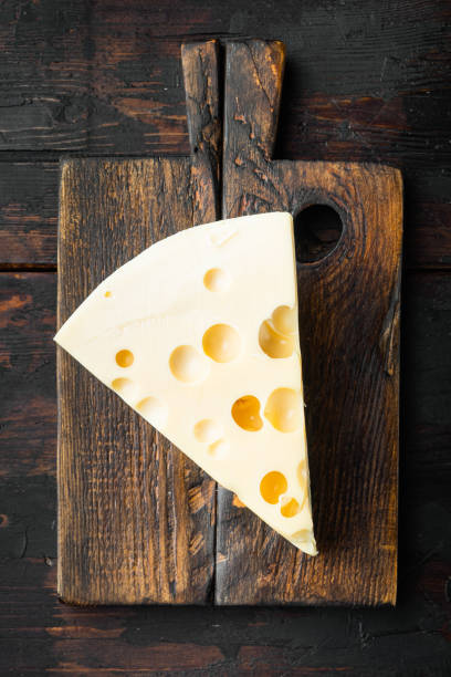 istock Maasdam cheese, on old dark  wooden table , top view flat lay 1316780605