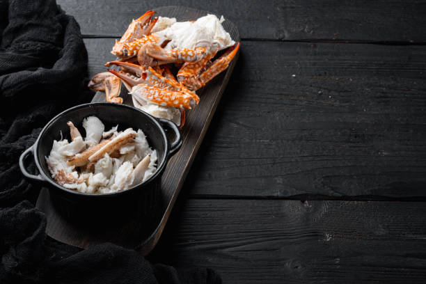 istock Boiled blue swimming crab claws, on black wooden table background  , with copyspace  and space for text 1316781468