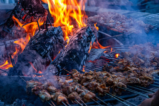 istock Shish kebabs on a very large barbecue ready to be cooked 1316781809