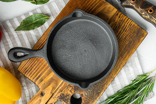 Empty frying cast iron pan background, kitchenware cooking concept set, on white stone  surface, top view flat lay, with copy space for text