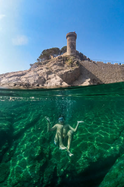 istock Little boy snorkeling with a castle in the background 1316782969