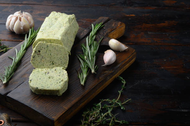 istock Dairy green butter with herbs, on old dark  wooden table background 1316784216