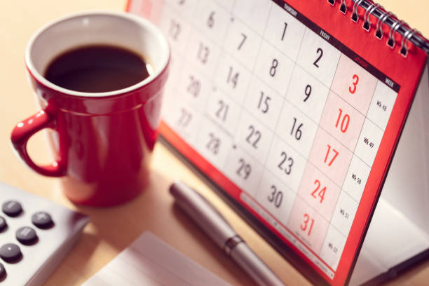Calendar on desk in office with calculator and pen, business deadline, appointment and meeting concept