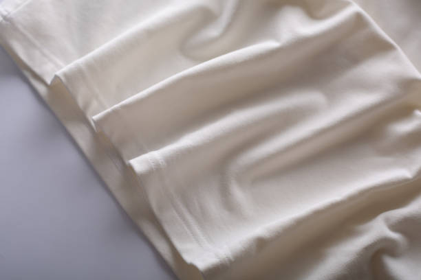 istock texture clothing waves. White fabric texture background. 1316784498