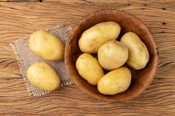 istock Potatoes in a bowl over wooden table 1316784729