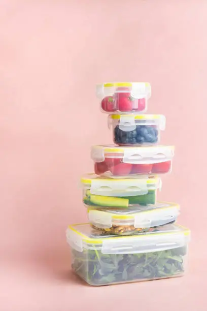 Photo of Reusable plastic containers with vegetables and berries