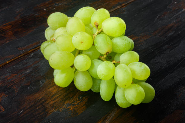 istock Shine Grape fruit, green fruits, on old dark  wooden table 1316792880