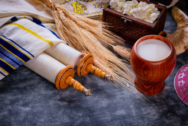 Jewish holiday Shavuot for kosher dairy food on torah scroll and tallis Jewish holiday Shavuot for kosher set dairy food on torah scroll and tallis simchat torah photos stock pictures, royalty-free photos & images