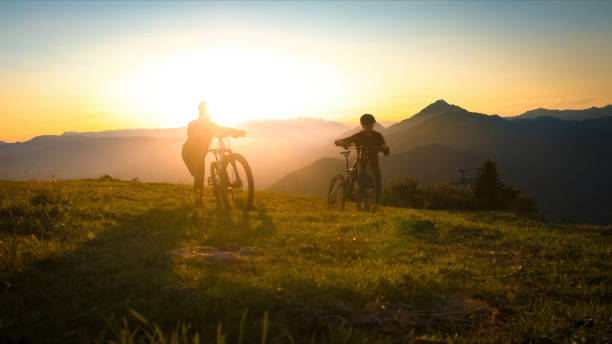 istock Pushing bikes over the grassy hill 1316795145