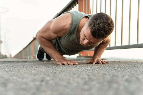 istock Muscular man is doing push-ups during calisthenic workout on a street 1316796427