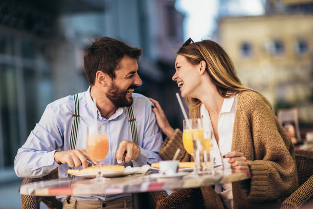 istock Young couple sitting in a restaurant eating pizza 1316796543
