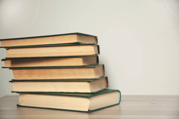 istock Empty wooden table with books background 1316798355