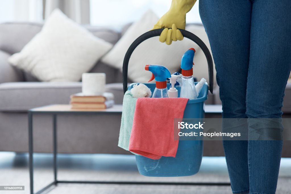 Shot of an unrecognizable woman holding a bucket of cleaning detergent before mopping her floors at home These floors are about to shine Cleaning Stock Photo