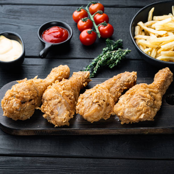 istock Fried crispy chicken legs, drumstick  on black wooden table 1316800943
