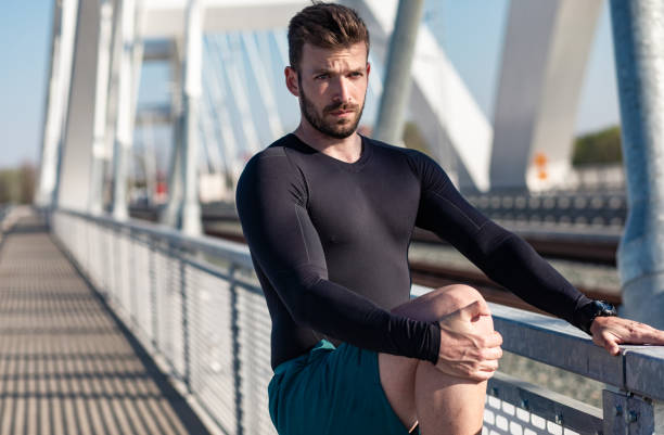 istock Man stretching his muscles before before running on the bridge in the city. 1316803495