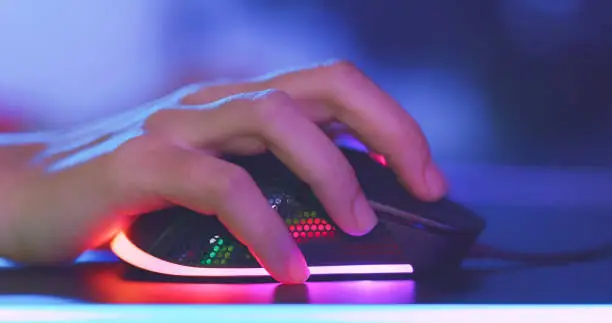 close up of pro cyber sport gamer play game with RGB mouse