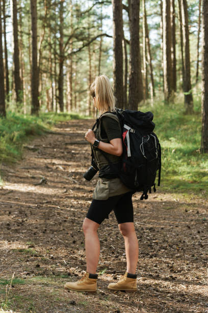 istock Female hiker with big backpack in green forest 1316805458