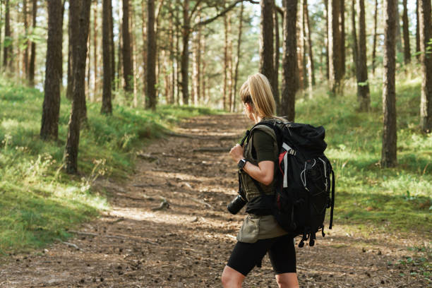istock Female hiker with big backpack in green forest 1316805476