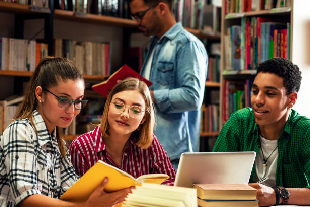 istock Three young students study in the school library and using laptop for researching online. 1316806508
