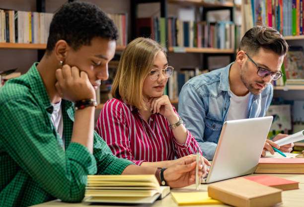 istock Three young students study in the school library and using laptop for researching online. 1316806606