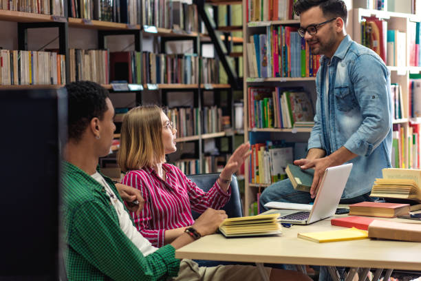 istock Three young students study in the school library and using laptop for researching online. 1316806819