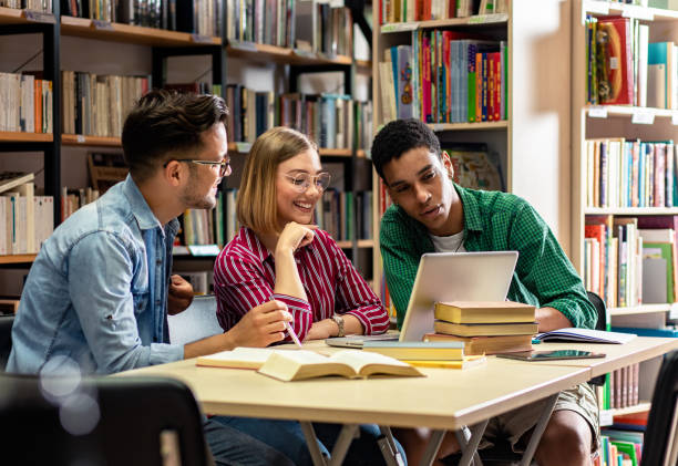 istock Three young students study in the school library and using laptop for researching online. 1316808589