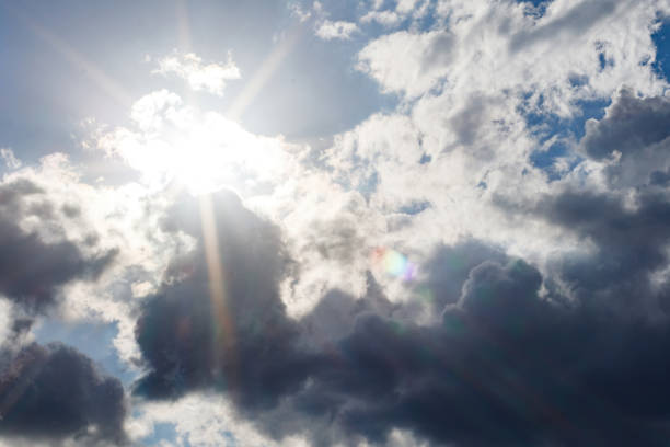 Cumulonimbus Clouds and Starburst Sun with Lens Flare stock photo
