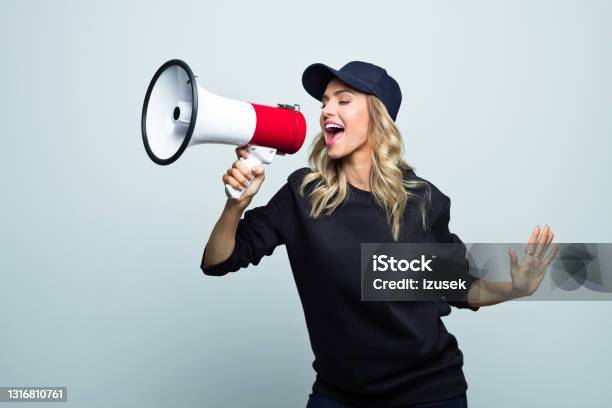 Portrait Of Excited Young Woman Stock Photo - Download Image Now - Excitement, Megaphone, Public Speaker