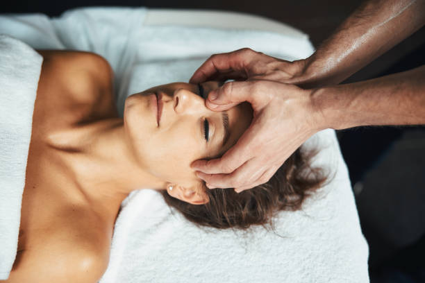 istock Adorable Caucasian woman lying on massage table while getting relax massage on head in wellnees center 1316810994