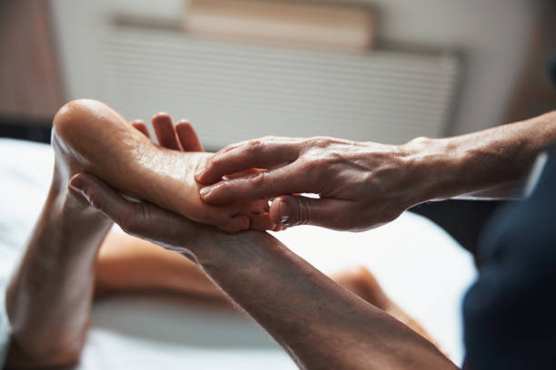 istock Unrecognized manual therapist doing massage on female feet in spa salon 1316811312