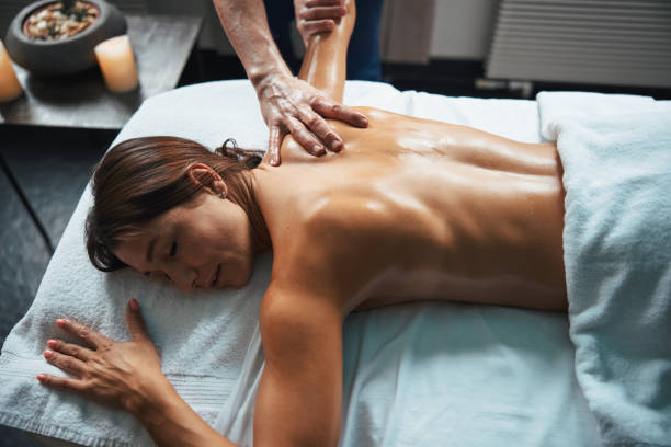 istock Adorable Caucasian female enjoy great time while lying on massage table and having spa treatment in beauty clinic 1316811378
