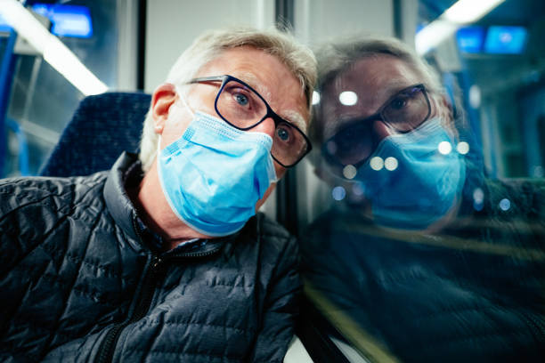 istock Thoughtful senior man wearing face mask on passenger train 1316818184