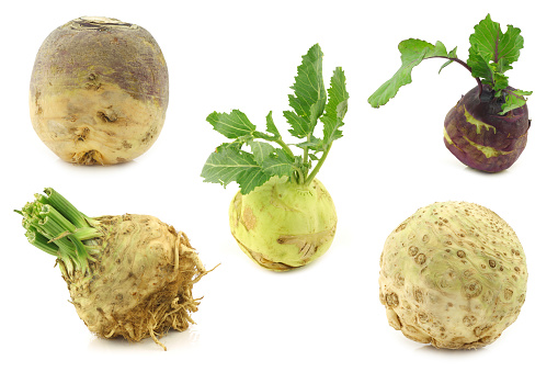 Assortment of root vegetables on a white background